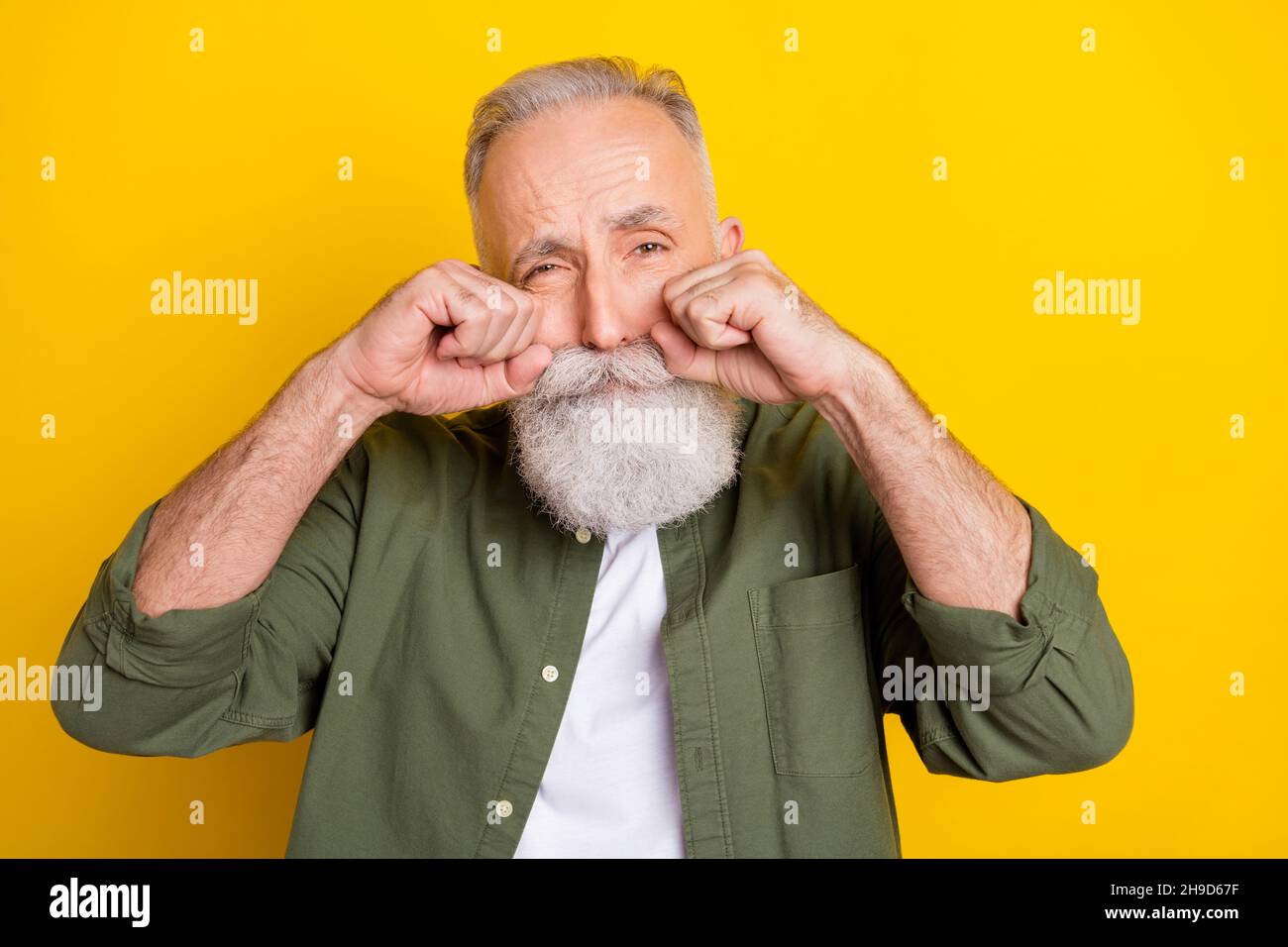 Photo portrait of grandfather sad got problem crying isolated bright yellow color background Stock Photo