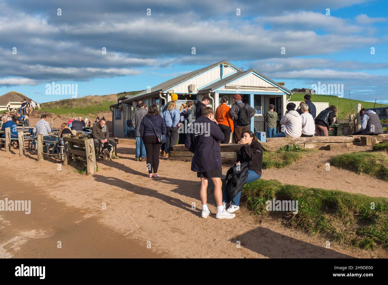 People outside the Beachhouse cafe and restaurant at South Milton Sands