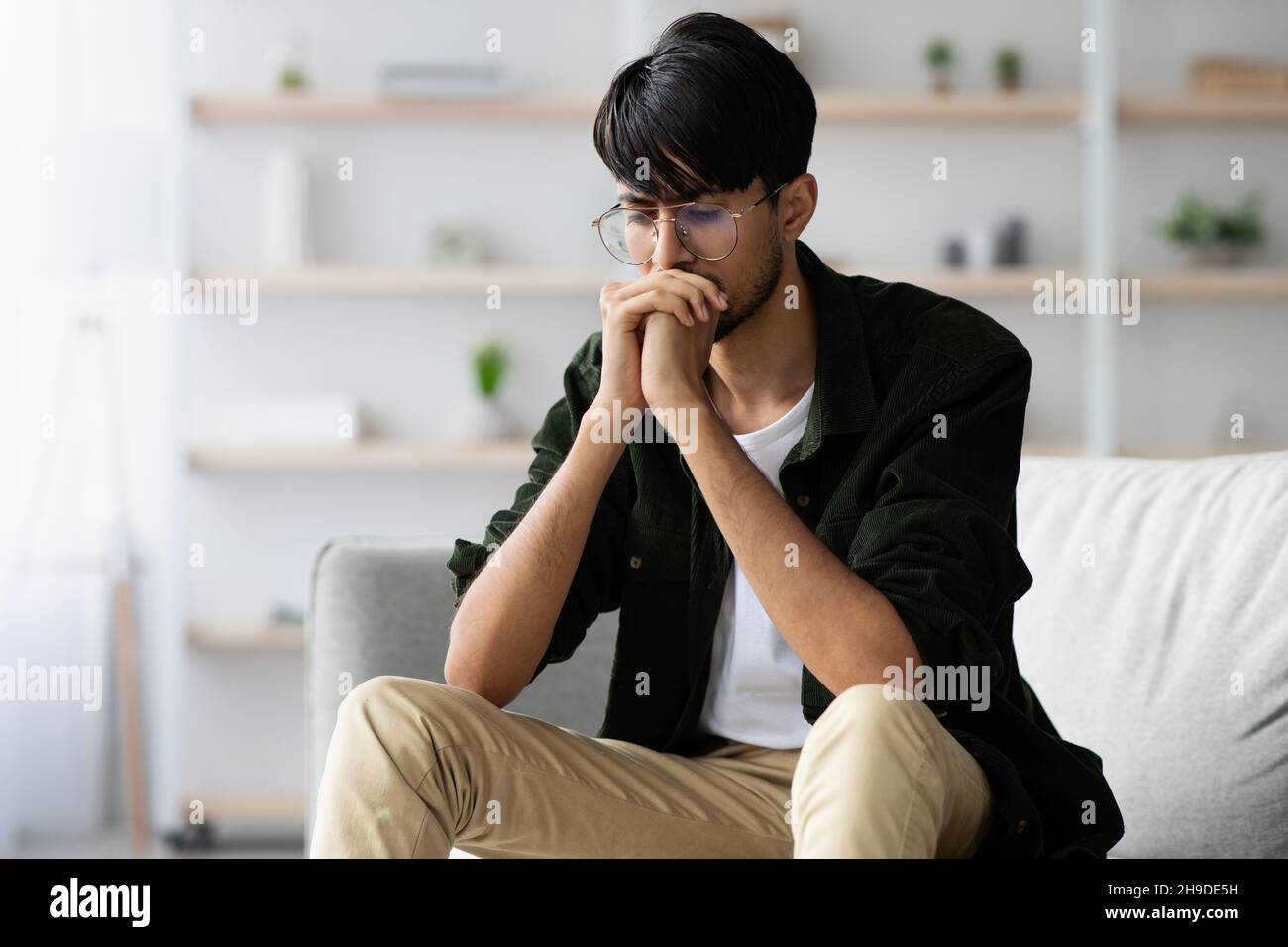 Stressed middle eastern young man suffering from crisis while pandemic Stock Photo