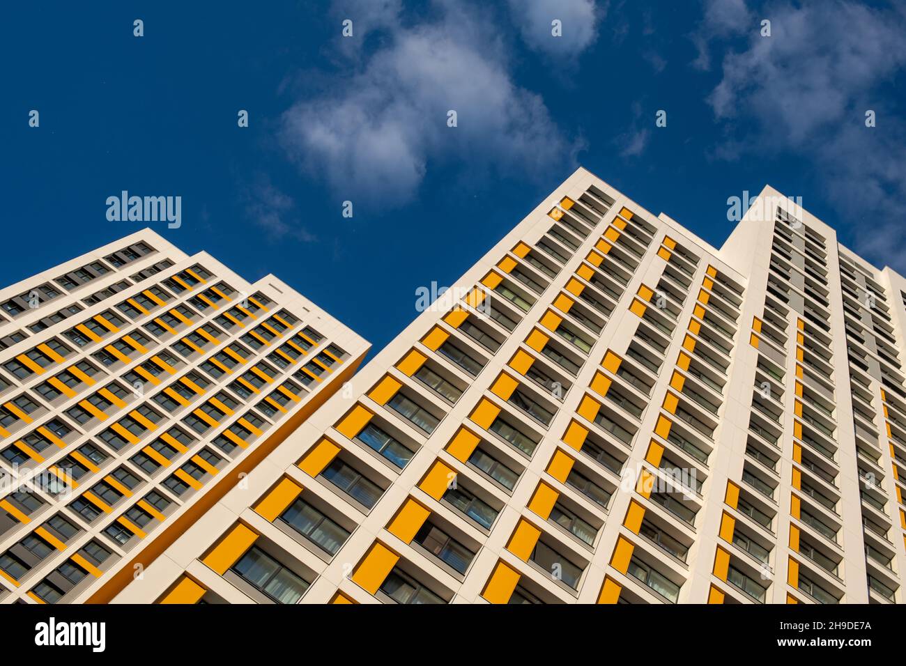 Modern building in a blue sky with clouds Stock Photo - Alamy