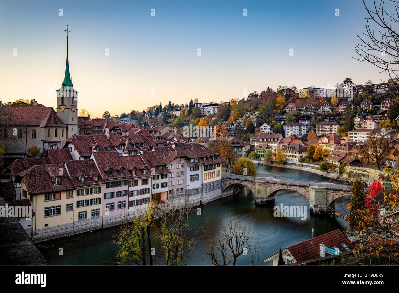 City of Bern with the Untertorbrücke bridge over the Aar river and the Nydeggkirche at sunset Stock Photo