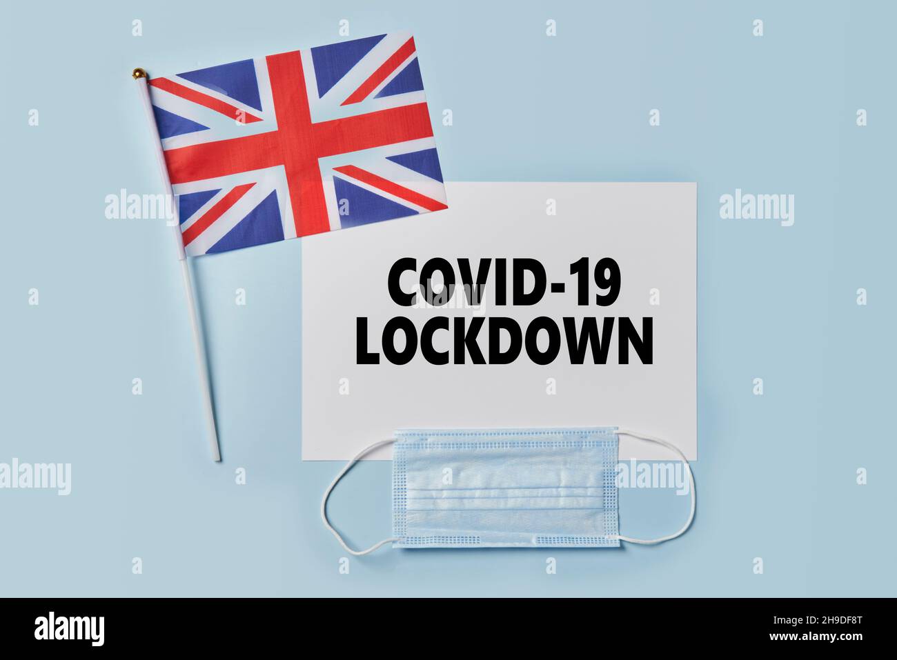Coronavirus new wave text on paper, UK national flag and face mask. Lockdown, quarantine due to new Covid-19 variant Stock Photo