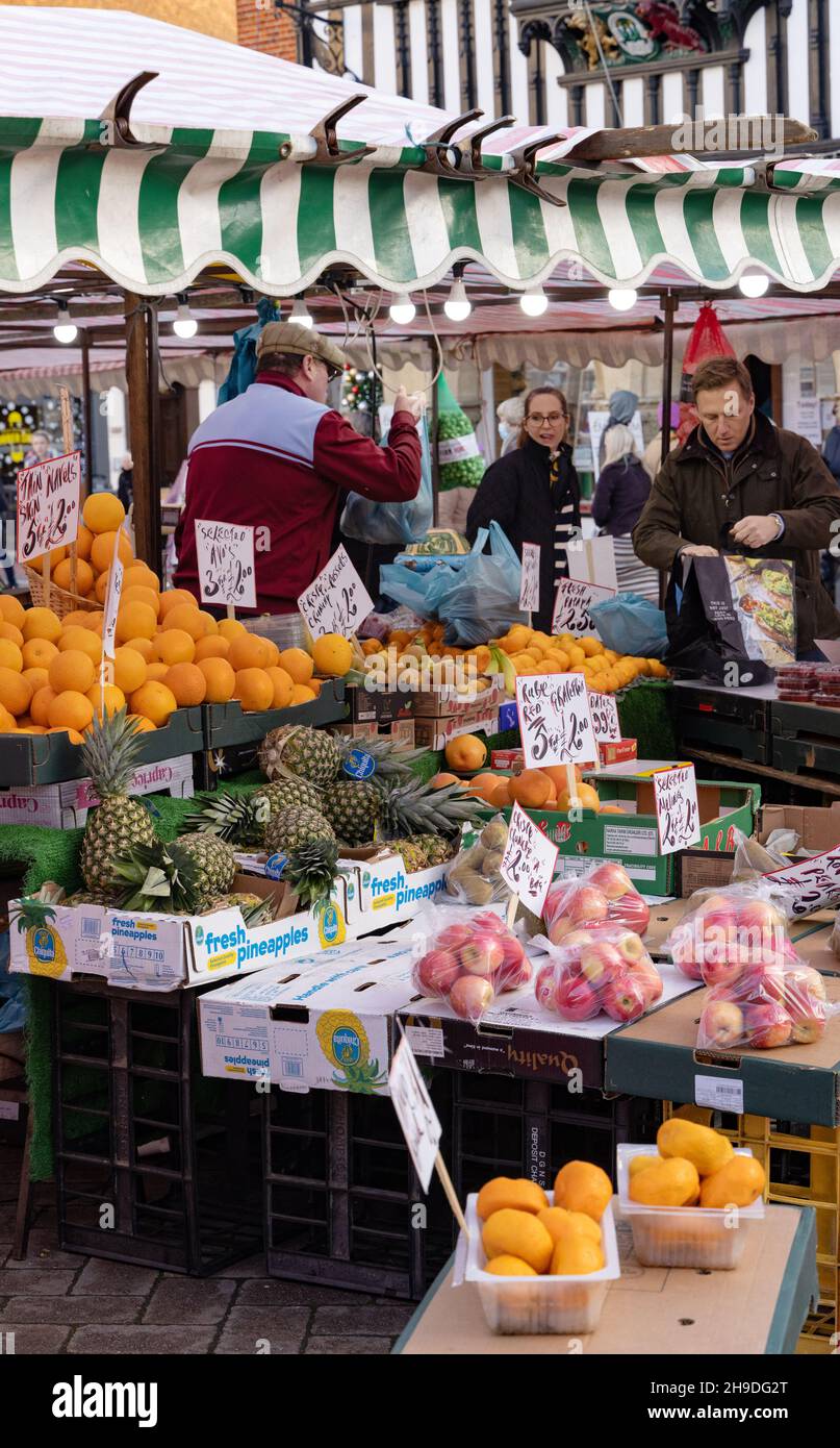 Fruit stall UK; people buying fruit at a fruit stall, Saffron Walden food market, Saffron Walden EssexEngland UK Stock Photo