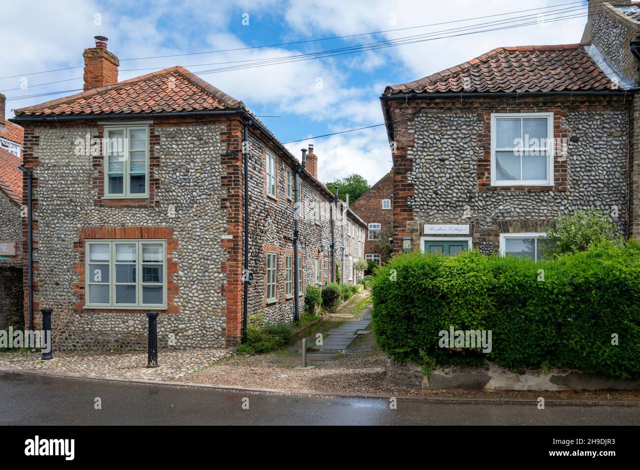 Old flint houses in the the village of Cley on the Norfolk coast UK Stock Photo