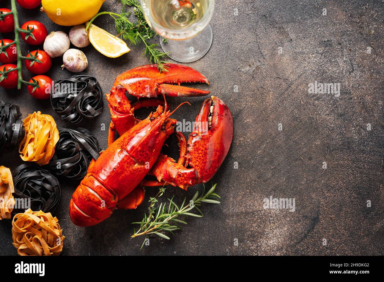 Food background with pasta, cooked lobster and wine Stock Photo