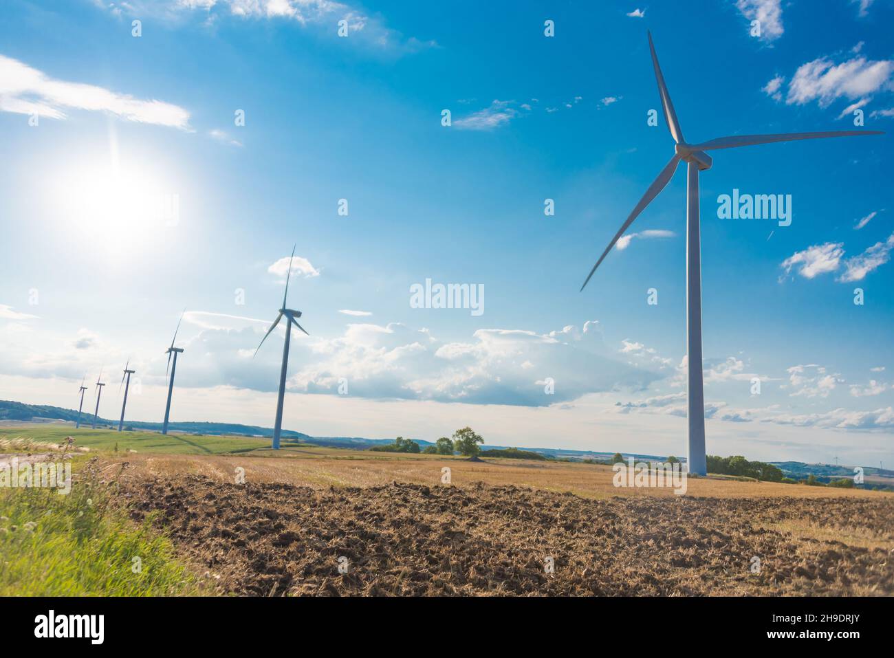 Wind turbines in a rural landscape on sky background Stock Photo - Alamy
