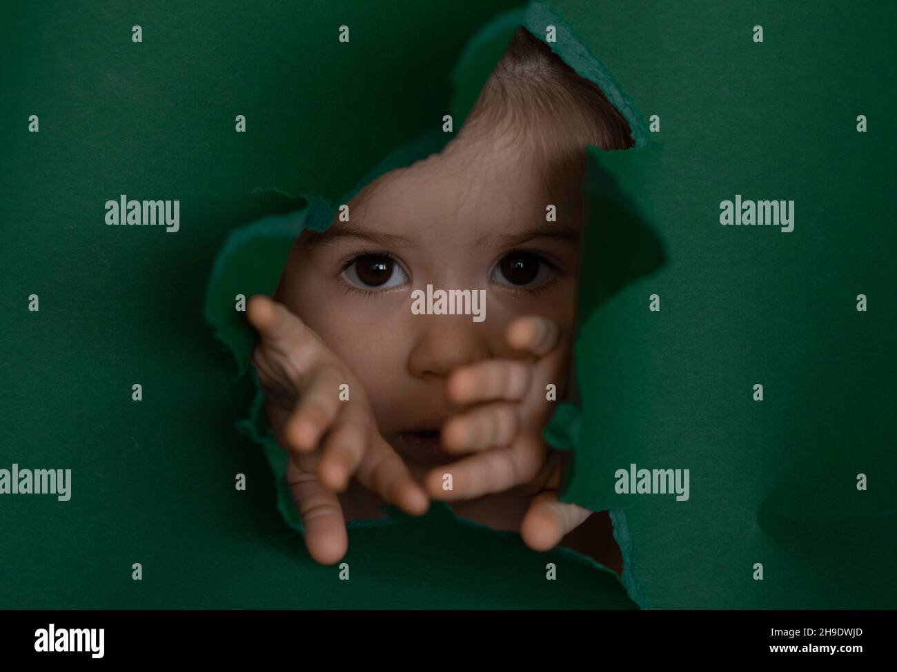 baby with opening by hands green pepper like new world. Stock Photo