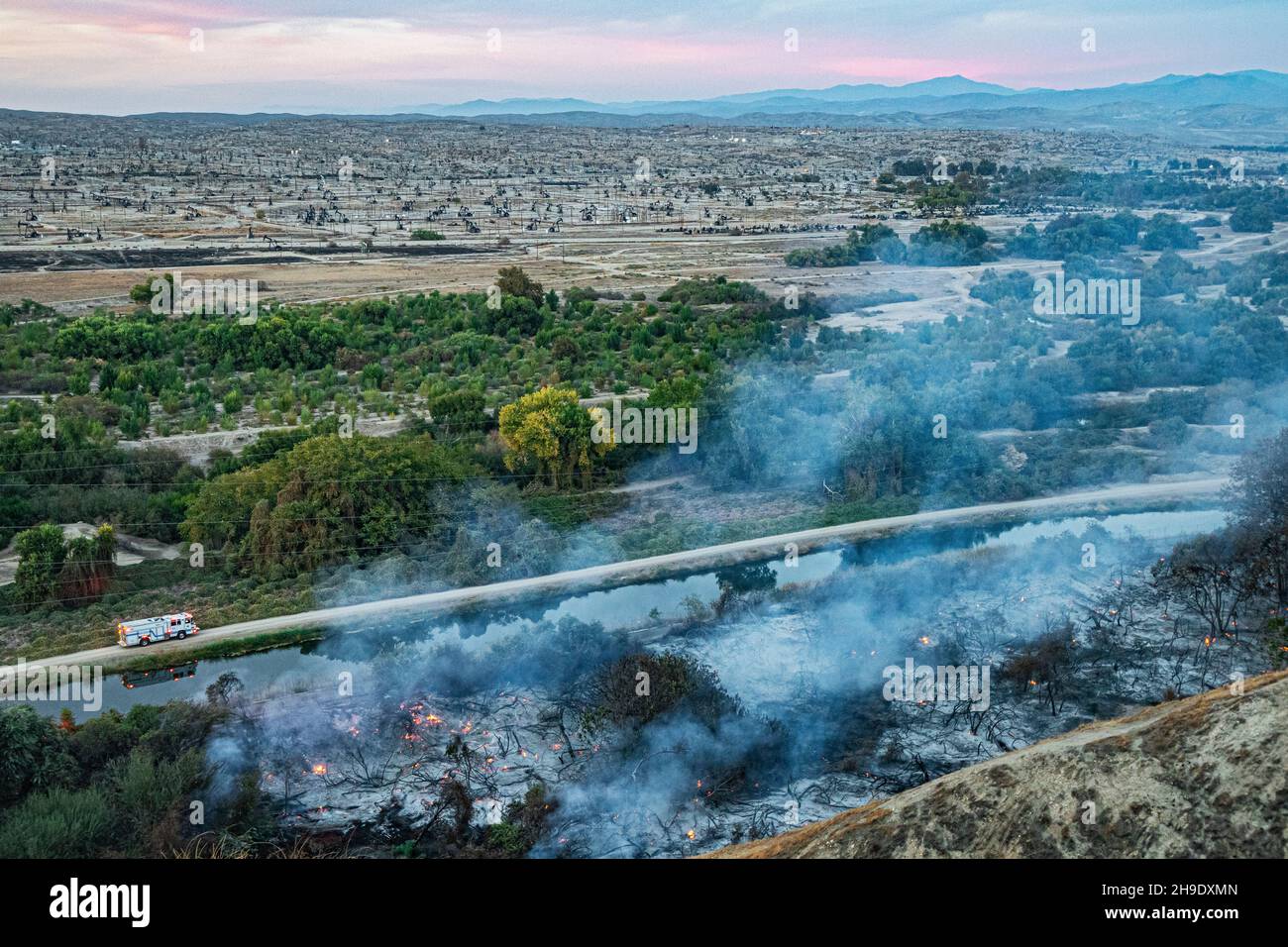 A wildfire breaks out on the edge of the Kern River Oil Field in