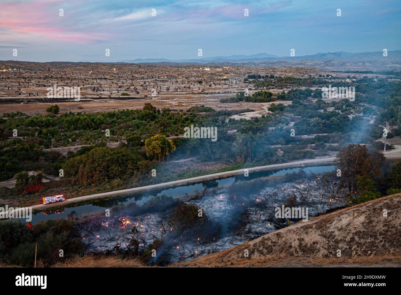 A wildfire breaks out on the edge of the Kern River Oil Field in