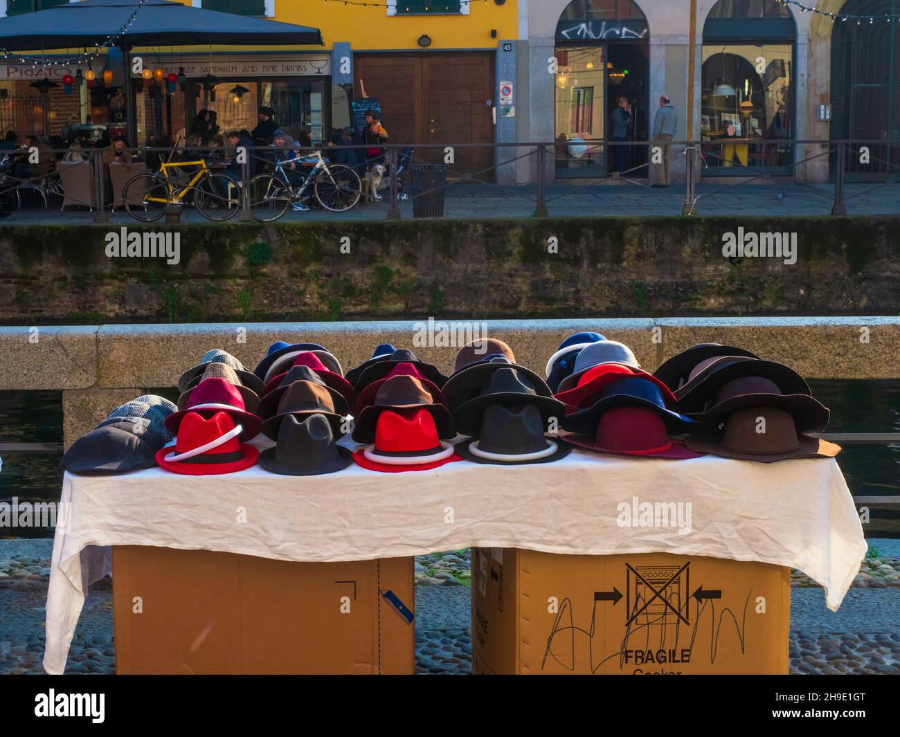 Milan, Lombardy, Italy.  December 2019.     Hat stand near a typical navigable canal, in the Navigli district of Milan. Stock Photo