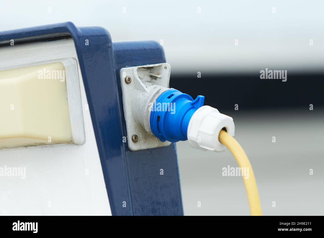 Electrical power socket bollard on pier. Charging station for boats in