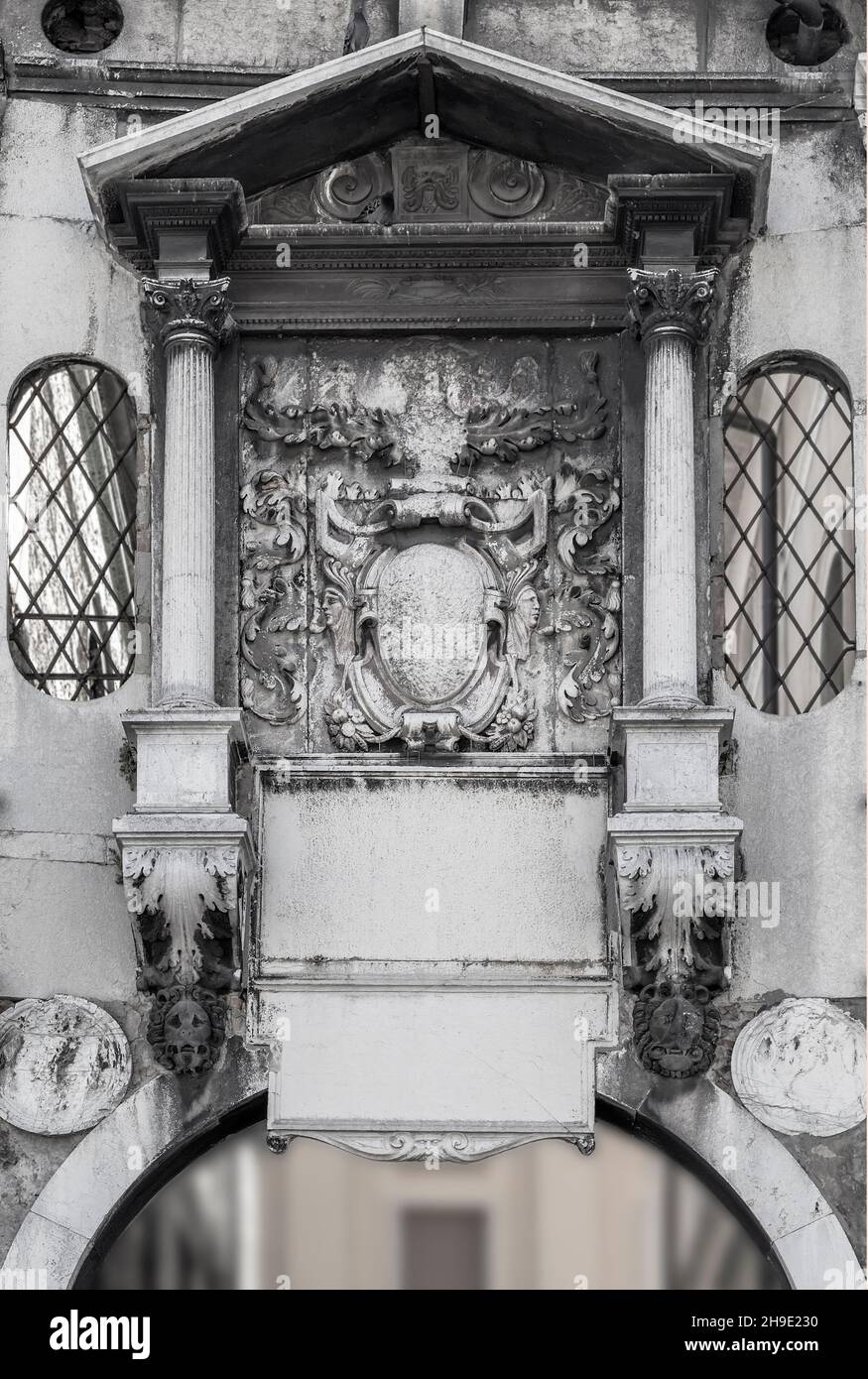 Fragment of the wall with a decorative canopy and bas-relief. Brescia. Italy Stock Photo