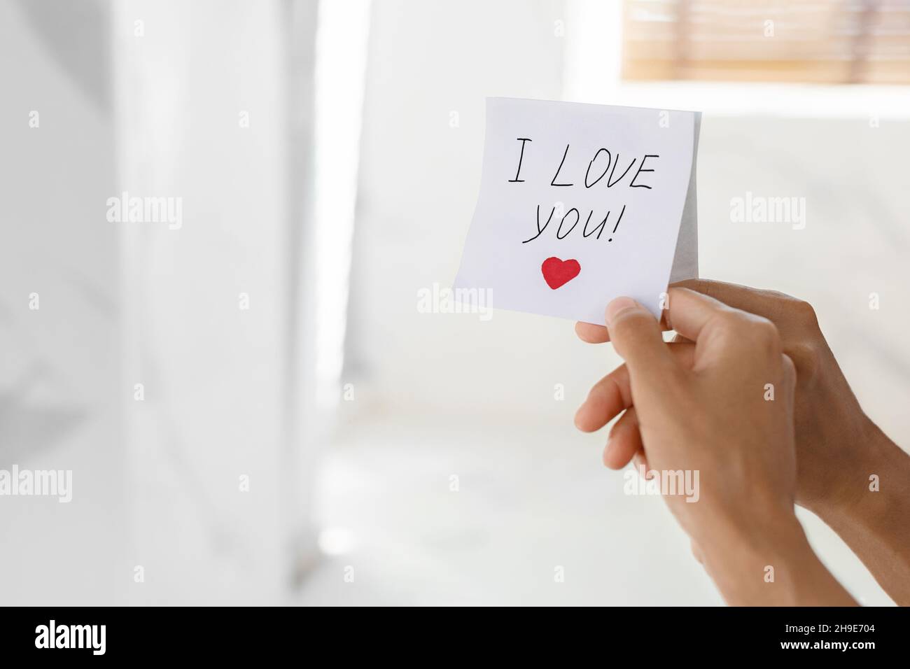 Unrecognizable Woman Putting Sticky Note With I Love You Text On Mirror Stock Photo