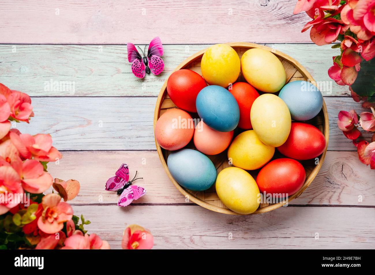 Easter eggs on pink background with flowers Stock Photo - Alamy