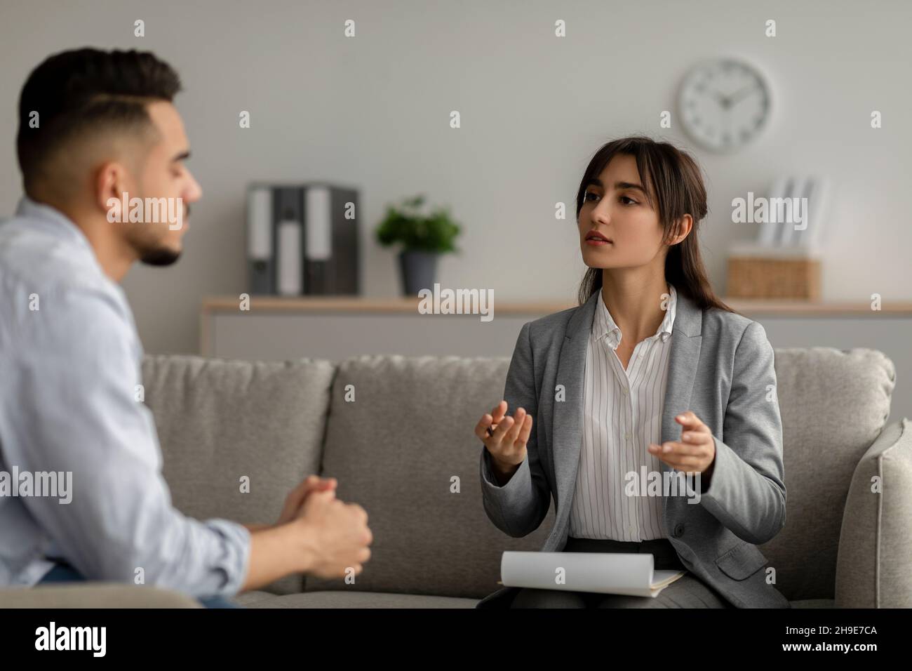 Mental health care concept. Arab guy speaking to psychologist