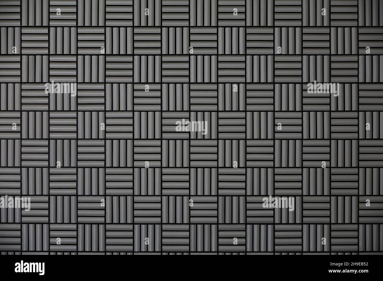Gray tile wall with geometric pattern as background material Stock Photo
