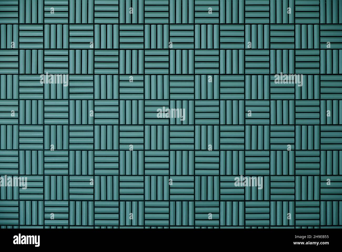 Green tile wall with geometric pattern as background material Stock Photo