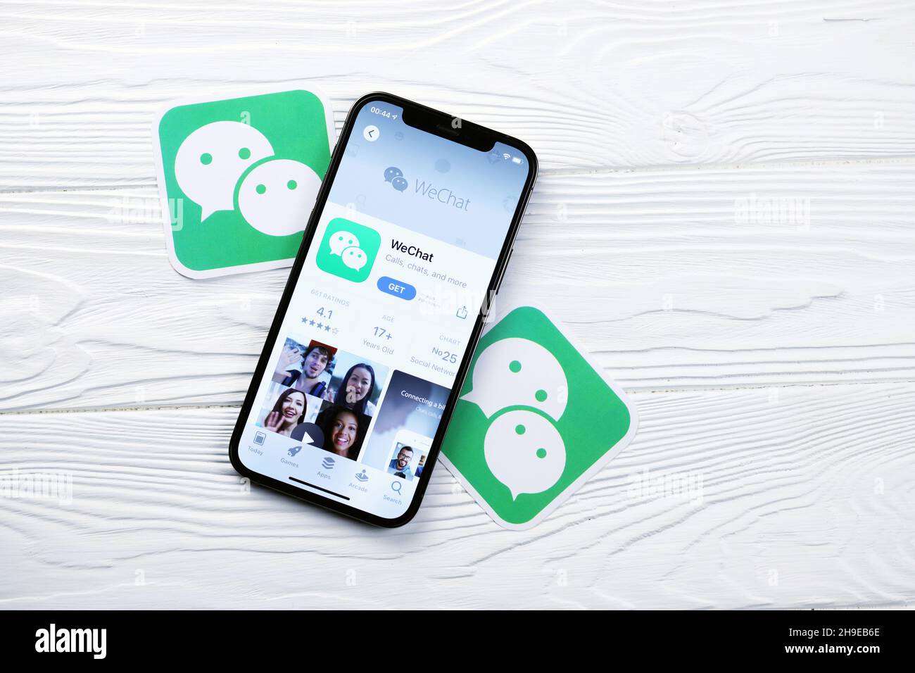 KHARKOV, UKRAINE - MARCH 5, 2021: Wechat messenger icon and application  from App store on iPhone 12 pro display screen on white wooden table Stock  Photo - Alamy