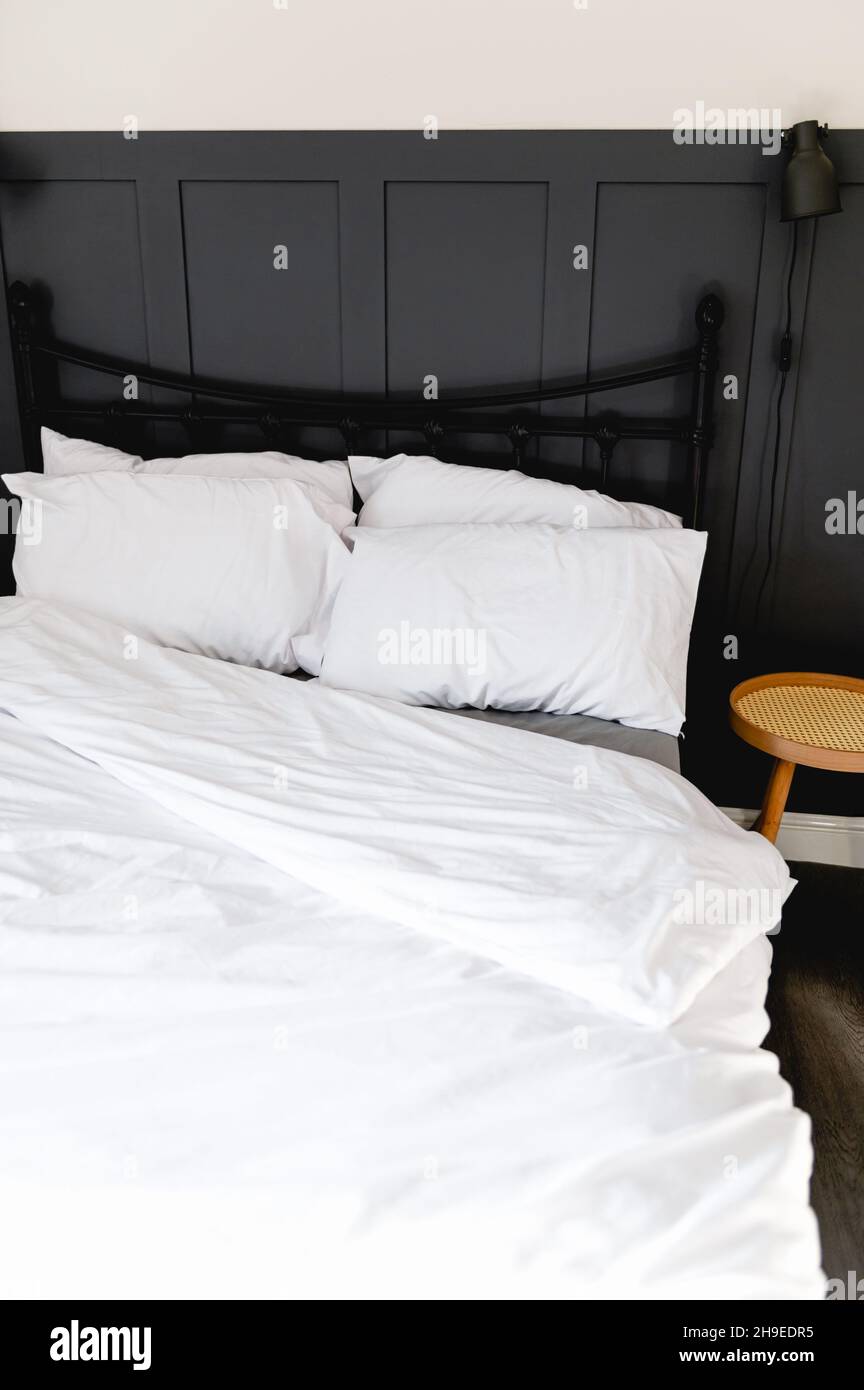 Soft pillows and duvet on comfortable bed Stock Photo
