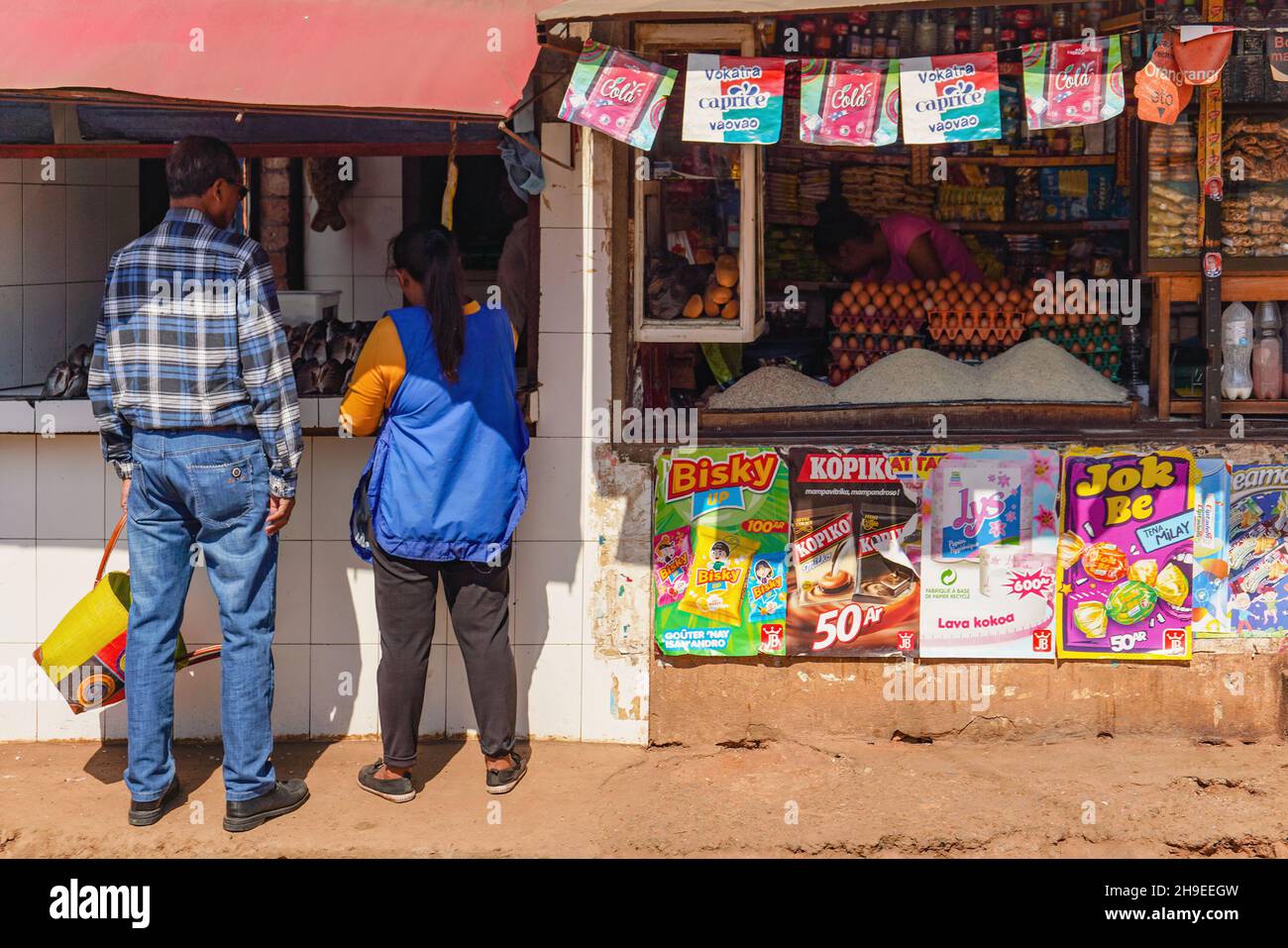 Antananarivo, Madagascar - May 07, 2019: Two unknown Malagasy people shopping at street fish shop. There are not many supermarkets in Africa, and most Stock Photo