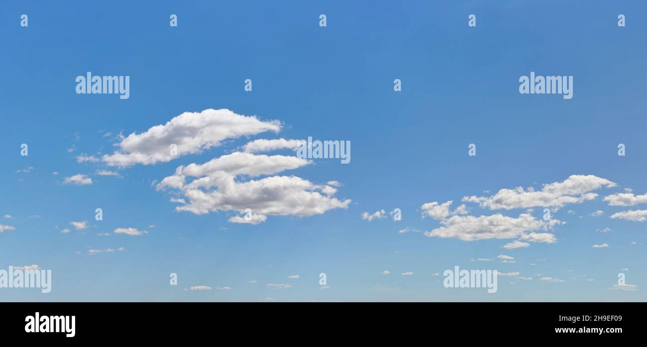 Bright sky background with few small clouds Stock Photo - Alamy
