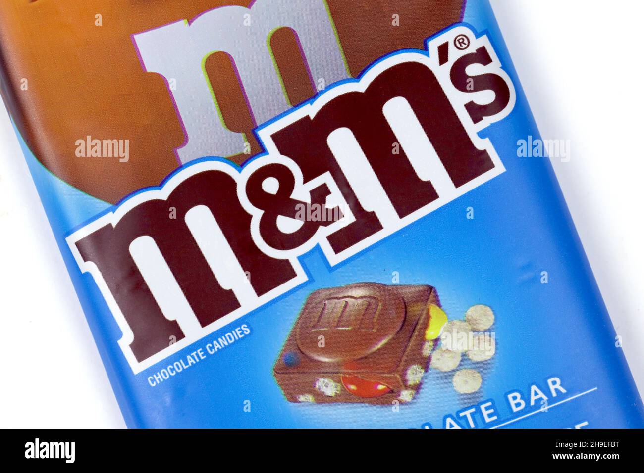 opened packet of crispy M&Ms with contents spilt to spell letters M  isolated on white background Stock Photo - Alamy