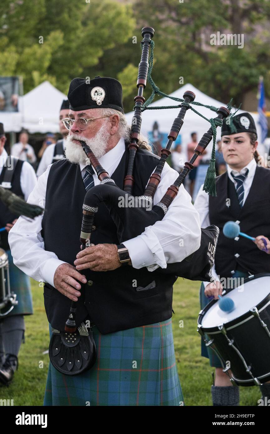 A bagpiper in full regalia performs at a Scottish festival in Moab