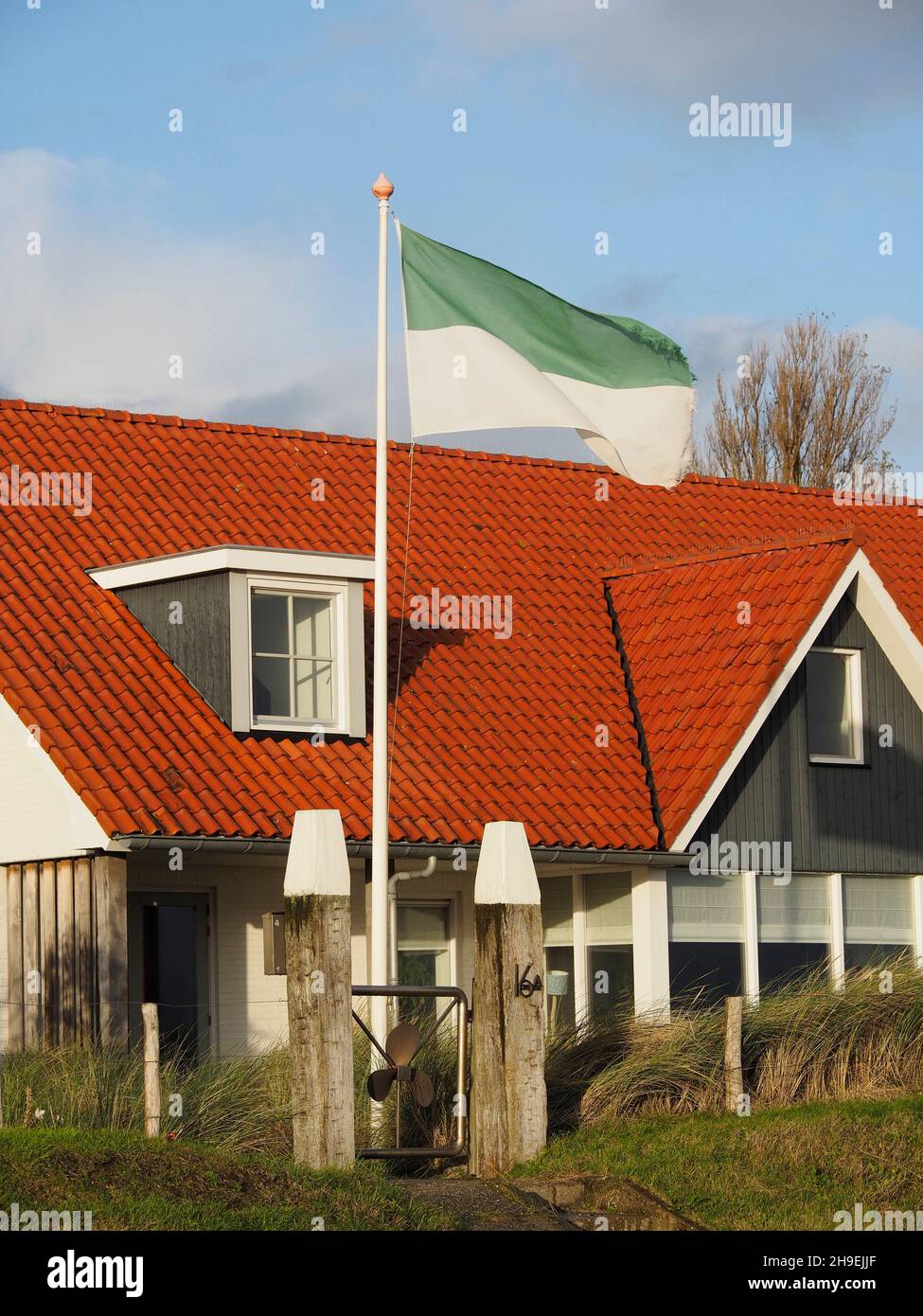 The Flag of Vlieland island is green and white and you see it everywhere on the island. Oost-Vlieland, Friesland, the Netherlands Stock Photo