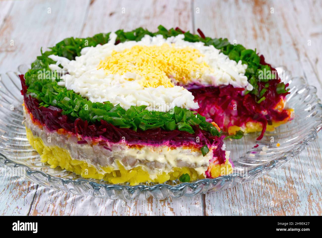 herring salad under a fur coat on the nice plate Stock Photo Alamy