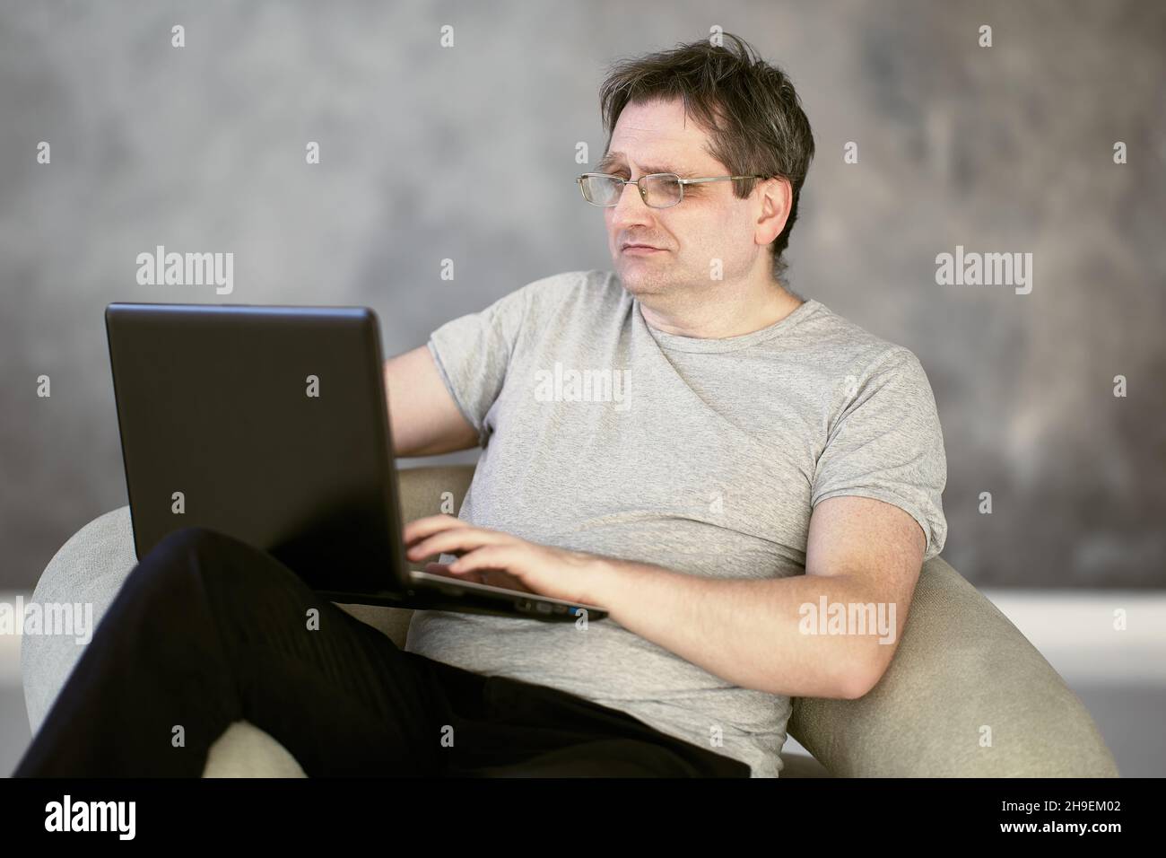 Presbyopia in 52 year old man working from home during lockdown due to coronavirus. Stock Photo