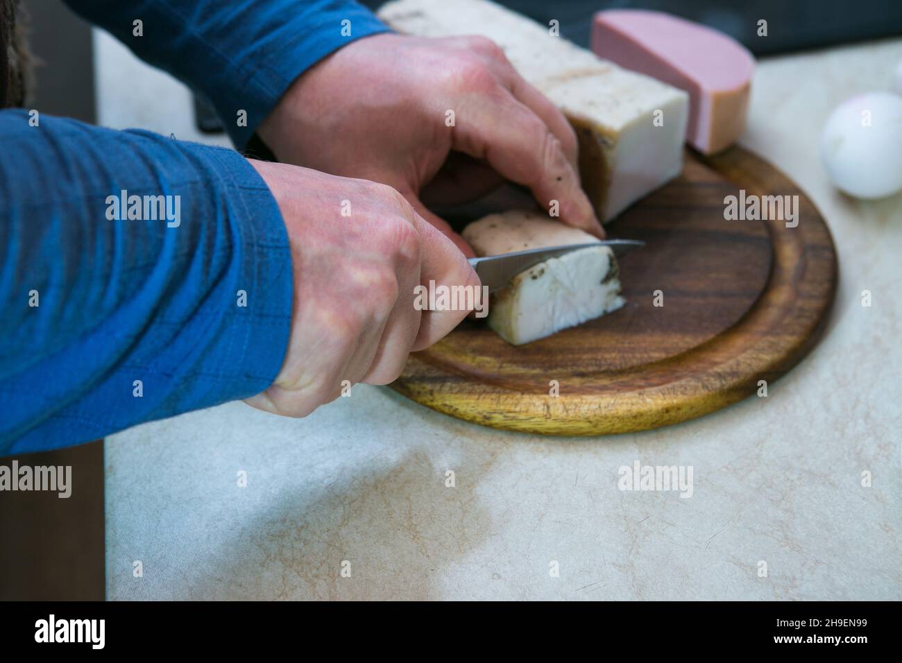 The process of making an omelet with lard and sausage. The man prepares