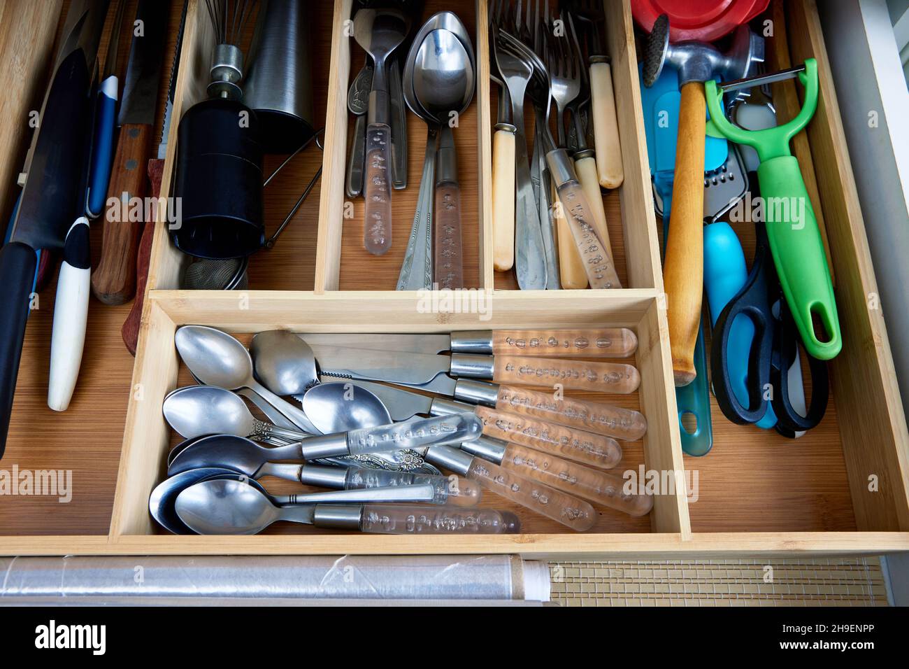 Insert bamboo cutlery tray drawer organizer with kitchen utensils Stock
