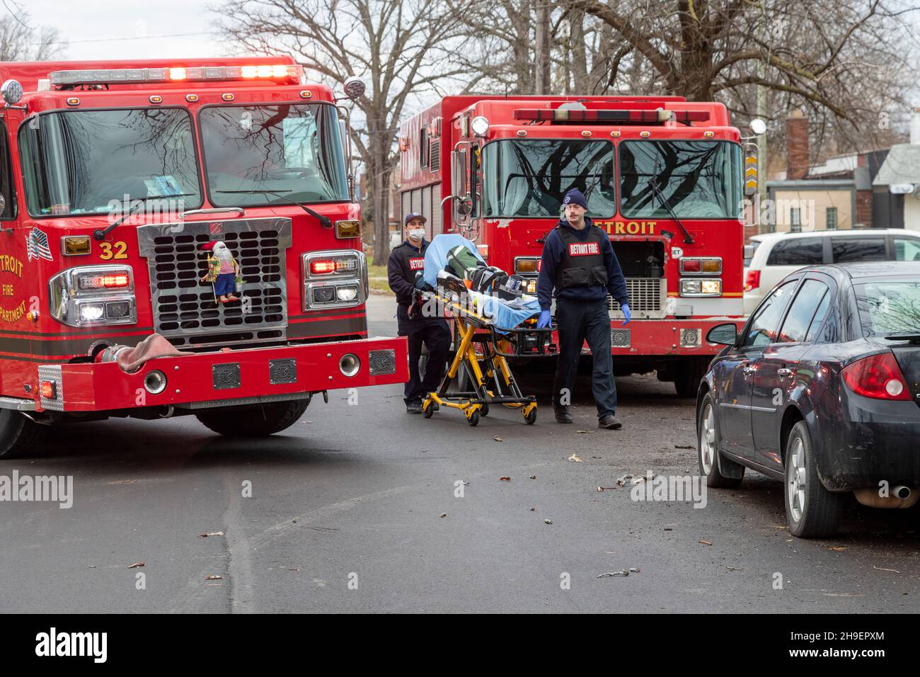 Detroit, Michigan - Emergency medical technicians at the scene of a fire which damaged a home in Detroit's Morningside neighborhood. Stock Photo