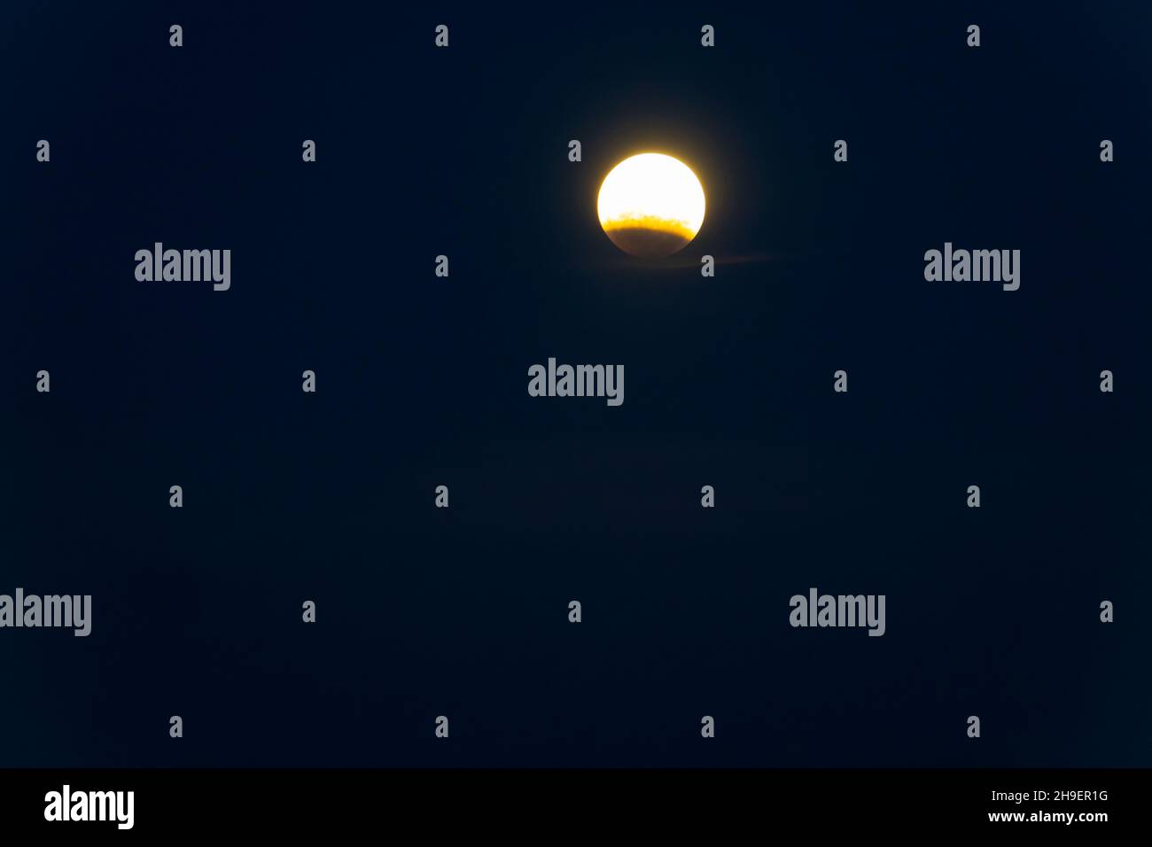 Moon during partial lunar eclipse over Tauranga in black night sky Stock Photo