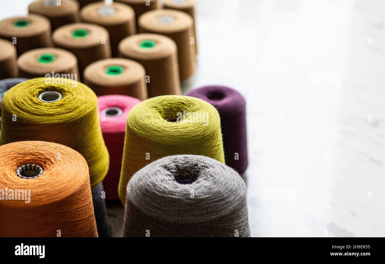 Several yarn bobbins of different colors and sizes Stock Photo - Alamy