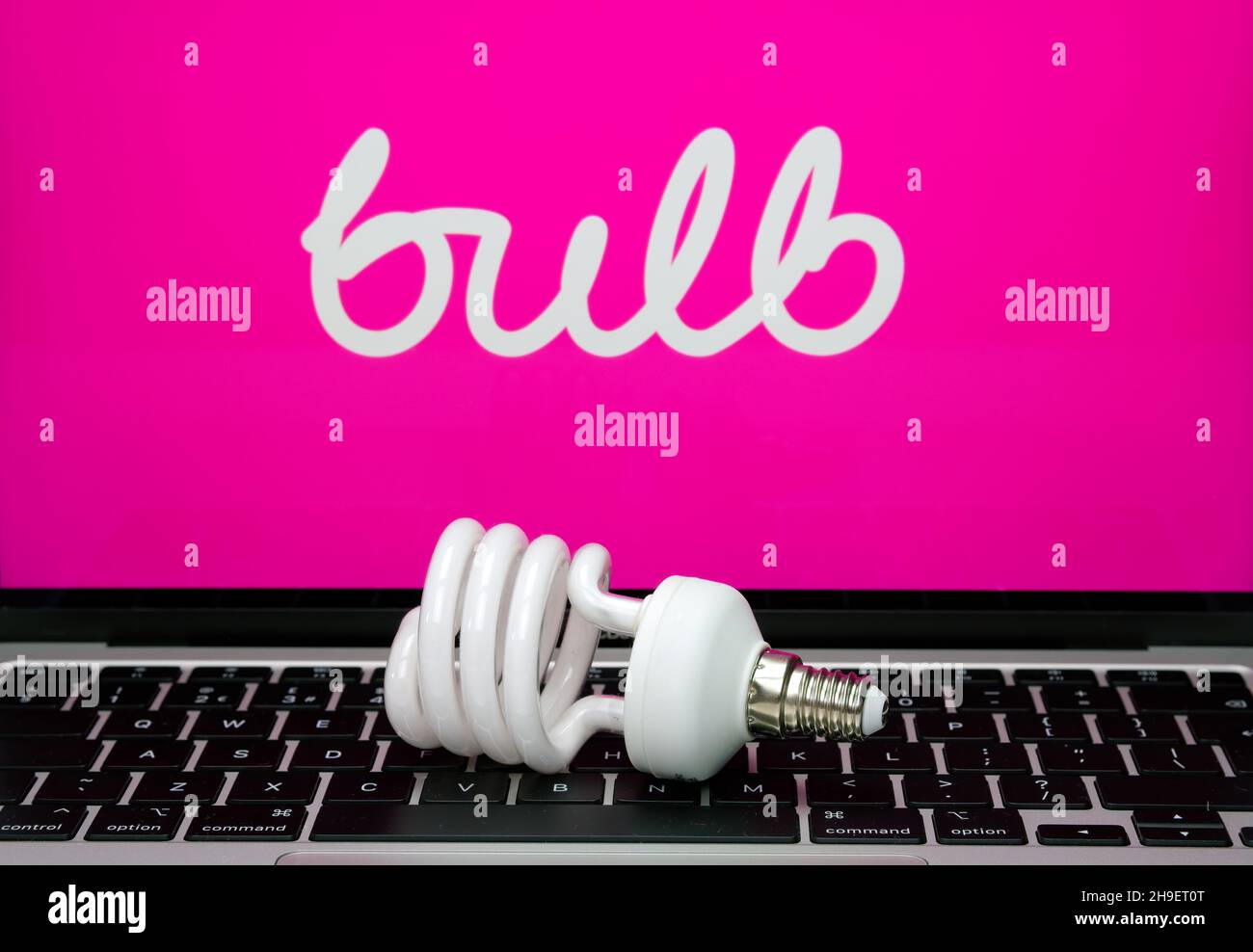 Energy saving bulb seen placed on laptop keyboard with blurred BULB