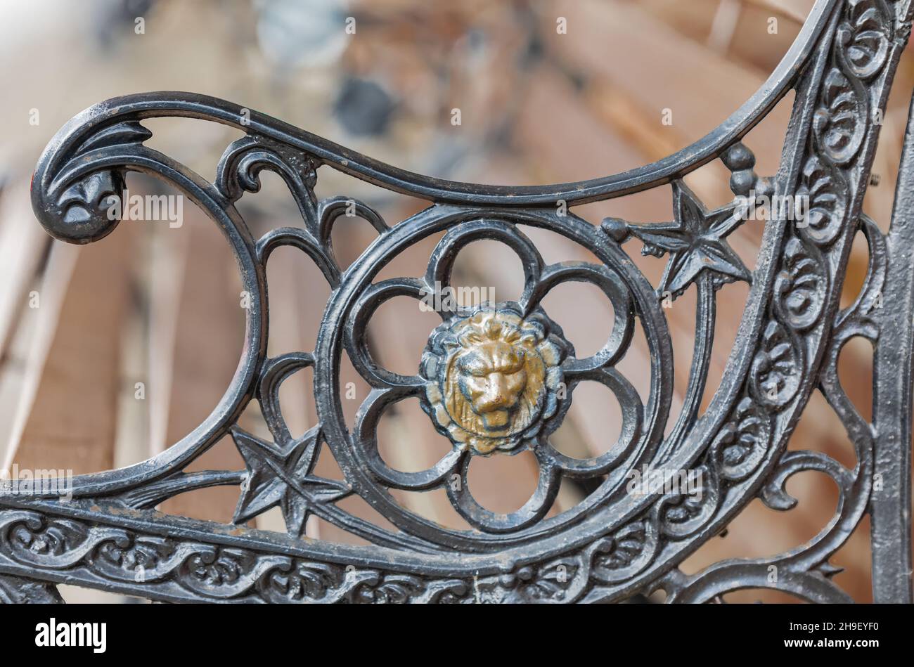 Detail of a molten iron railing bench in the park. Close up deatails of beautiful iron bench on a street. Stock Photo