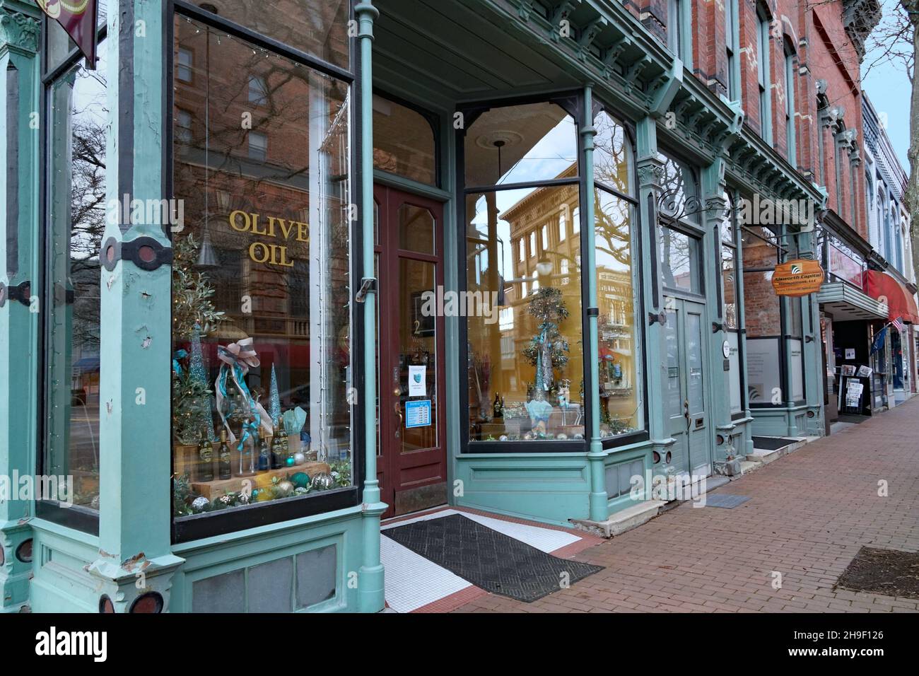 Corning, New York - November 19, 2021:  Market Street in the Gaffer District has well preserved 19th century buildings with interesting stores. Stock Photo