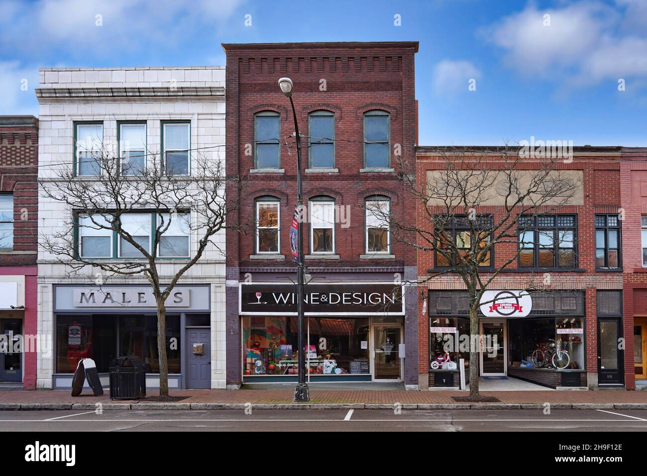 Corning, New York - November 19, 2021:  Market Street in the Gaffer District has well preserved 19th century buildings with interesting stores. Stock Photo