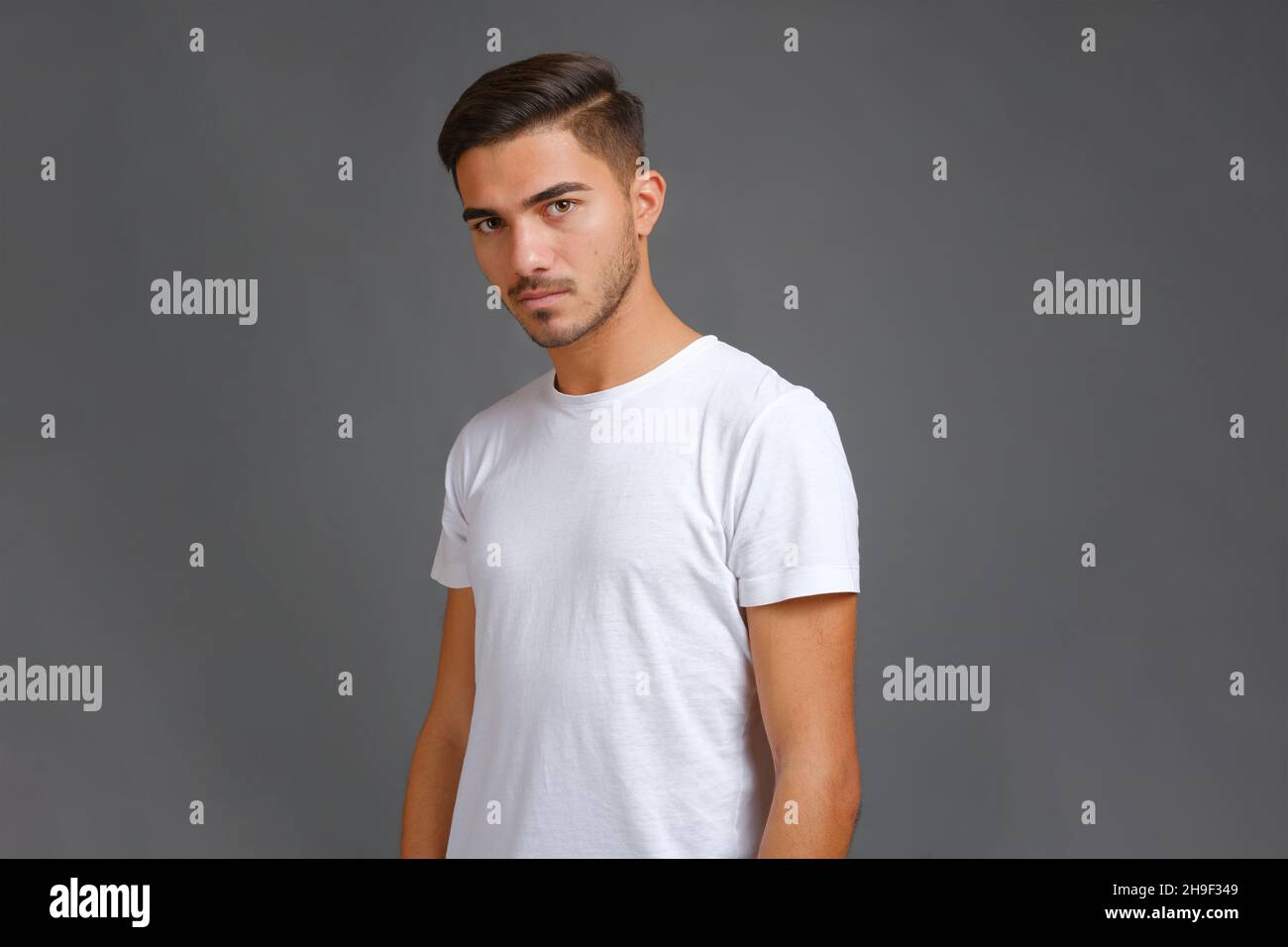 Portrait of serious young man in white t-shirt Stock Photo