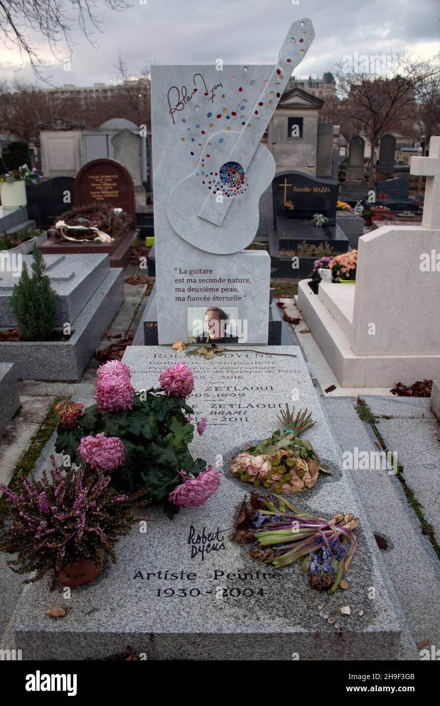 The guitar shaped gravestone for French classical guitarist, Roland Dyens  in the Montparnasse Cemetery in Paris Stock Photo - Alamy