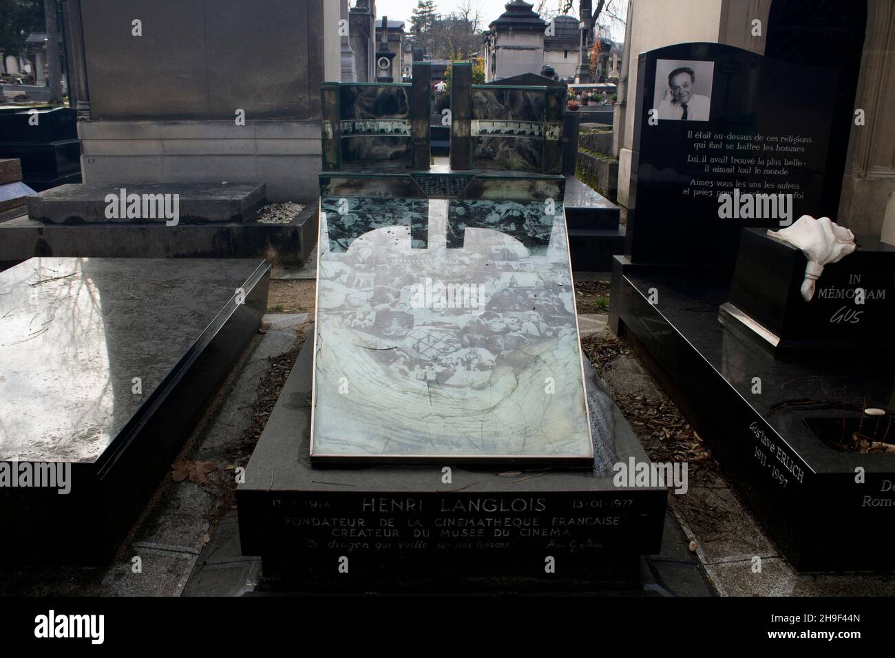 The grave of Henri Langlois - French film archivist and cinephile, and founder of the Cinemateque Francaise - decorated with film stills Montparnasse Stock Photo