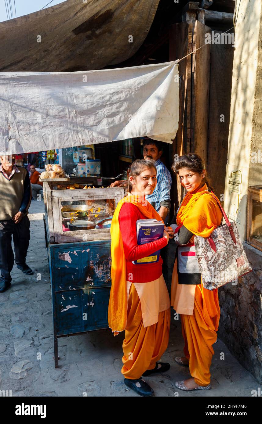 Two local young women students in traditional local dress in the street in Pragpur, a heritage village in Kagra district, Himachal Pradesh, India Stock Photo
