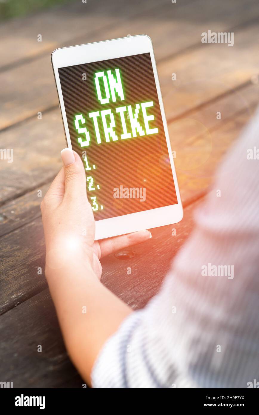 Text caption presenting On Strike. Business concept refuse to continue ...