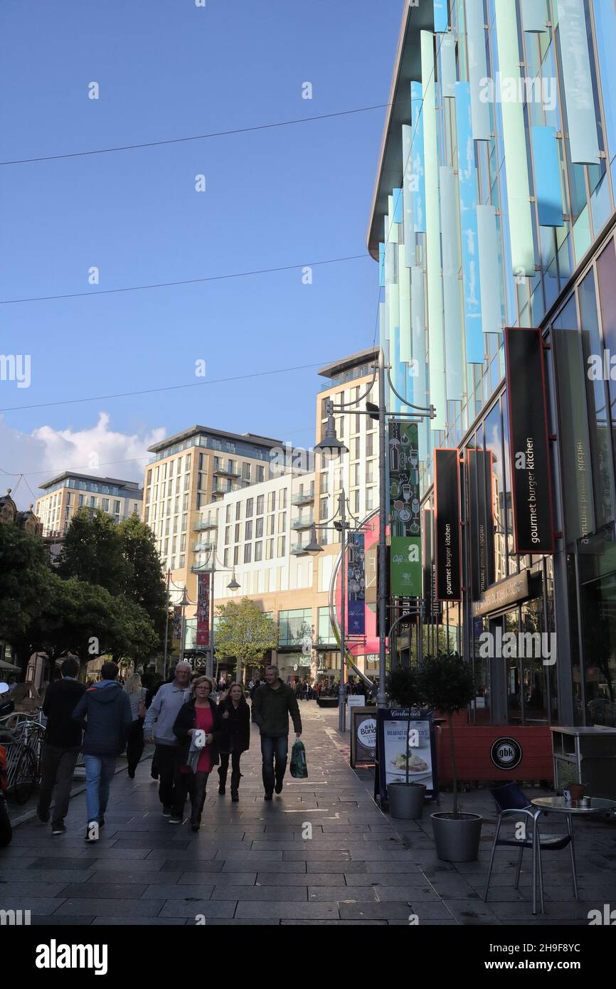 People on Mill Lane Cardiff city centre, skyline buildings in Wales UK Stock Photo