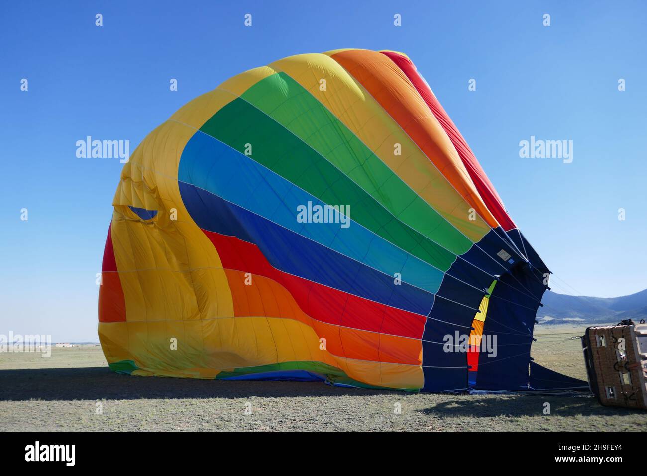 Deflating hot air balloon on ground Stock Photo Alamy