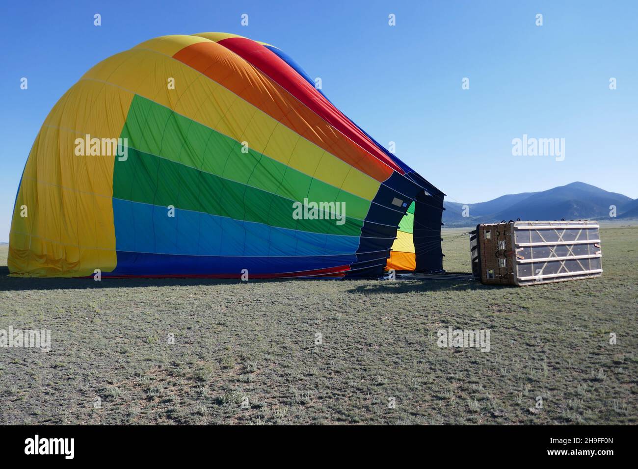 Hot air balloon landing site with balloon laying on ground Stock Photo