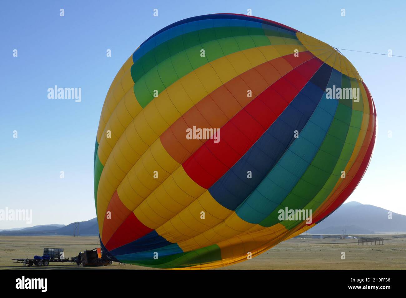Colorful hot air balloon and equipment after landing Stock Photo