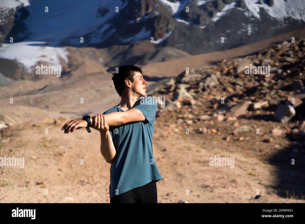 Man is warming up before running outdoor. Stock Photo