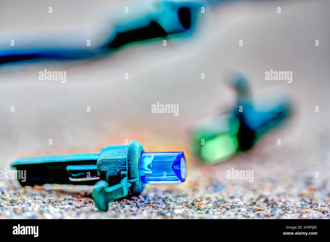 Focus on replacement bulb for a string of Christmas lights to repair a